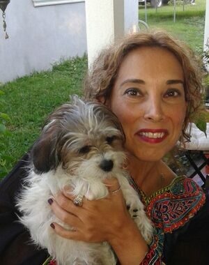 Mercedes "Mercy" Marquez, who hand-reviews every Pet Pic Portraits order, holding one of her dogs